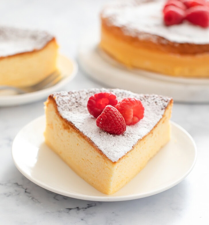 A slice of fluffy cheesecake topped with fresh fruit on a plate