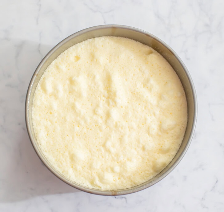 Cheesecake batter in a round cake pan