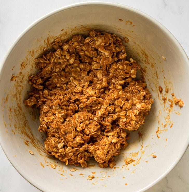 Peanut butter, maple syrup and oats mixed in a bowl