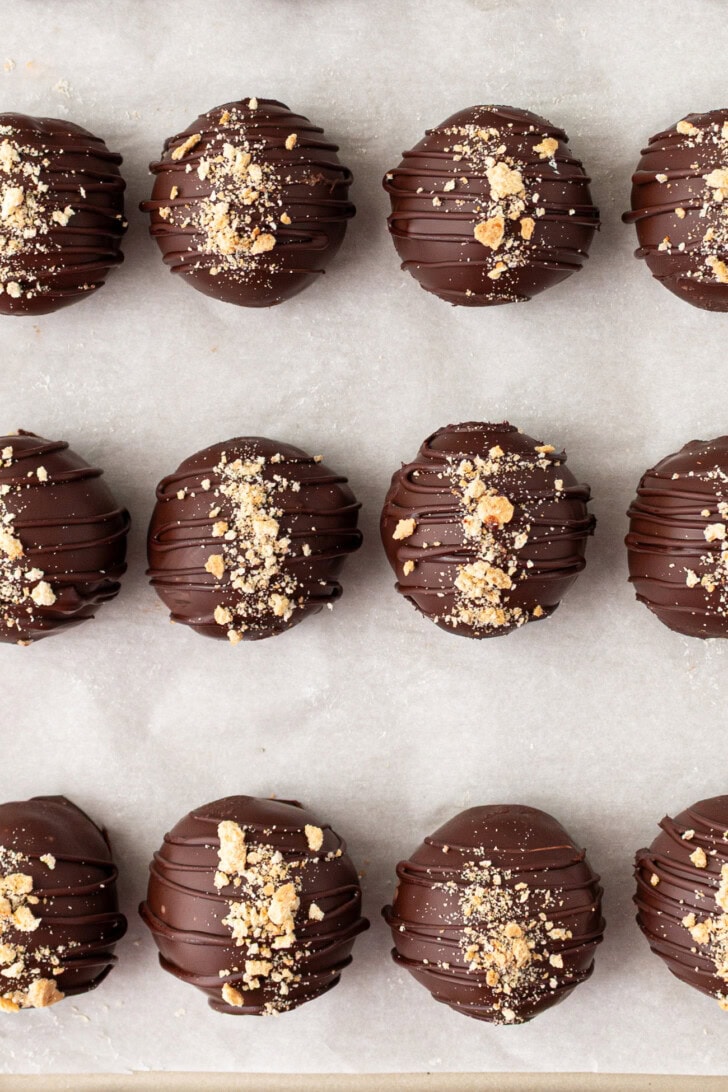 Cheesecake Balls dipped in chocolate with crushed graham crackers on top