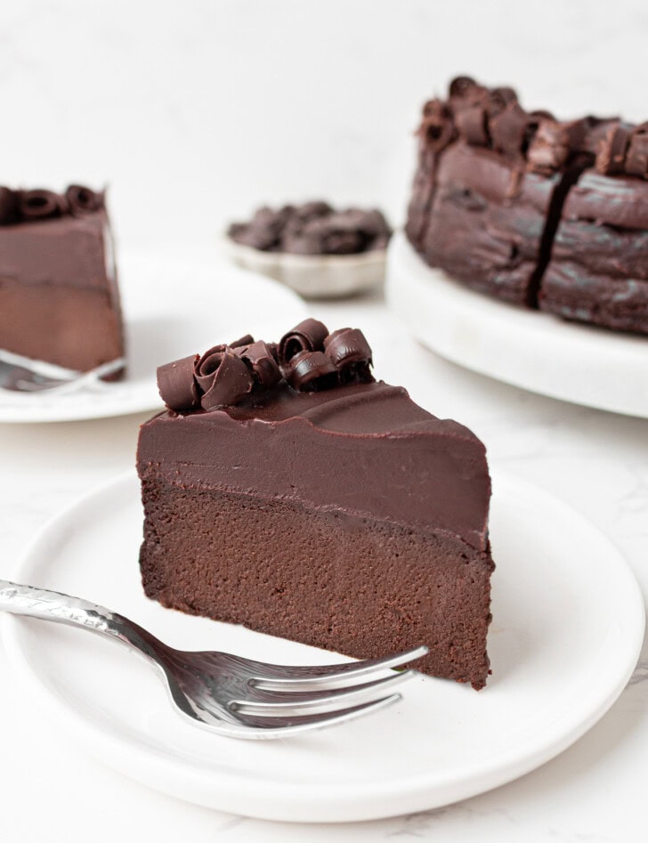A slice of chocolate cake with chocolate frosting on a plate
