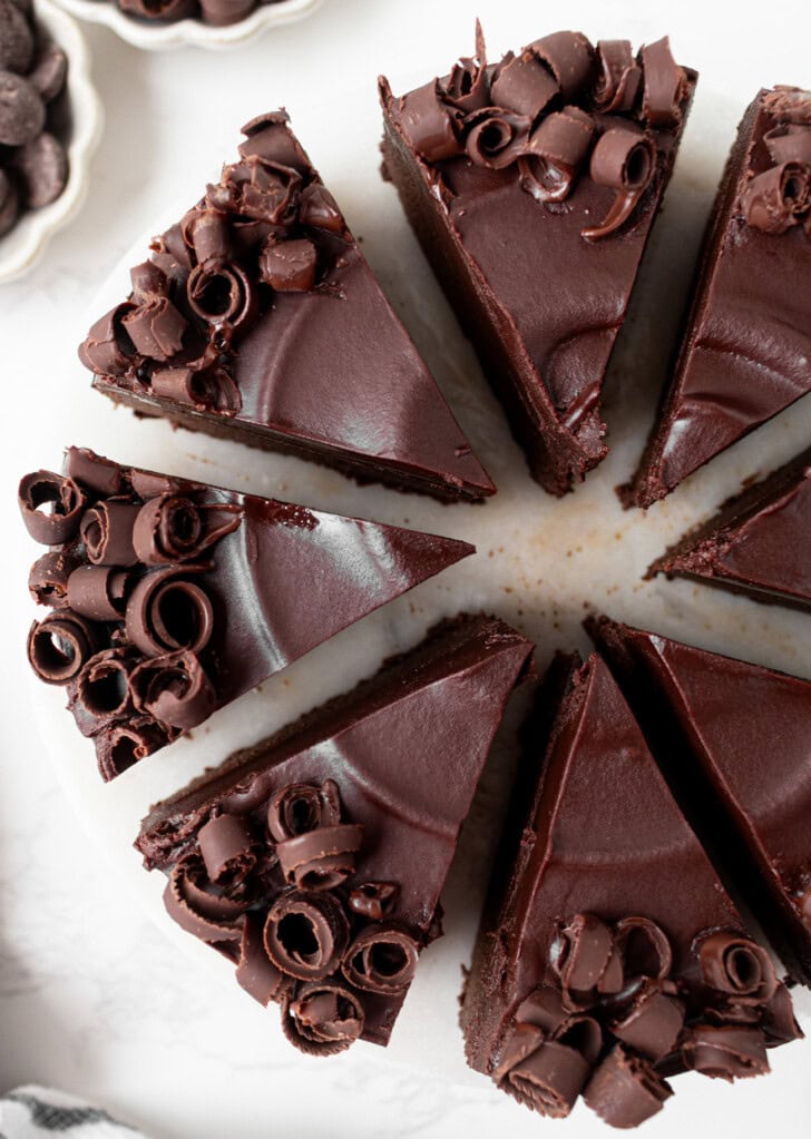 A chocolate cake decorated with frosting and chocolate curls