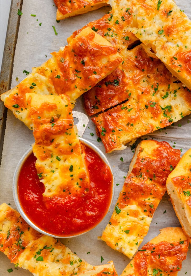 Cottage Cheese Breadsticks on a pan with dipping sauce