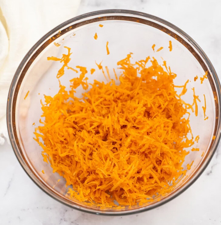 Shredded carrots in a glass bowl