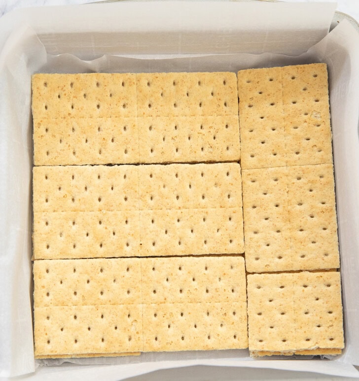 Graham crackers on the bottom of a square baking pan
