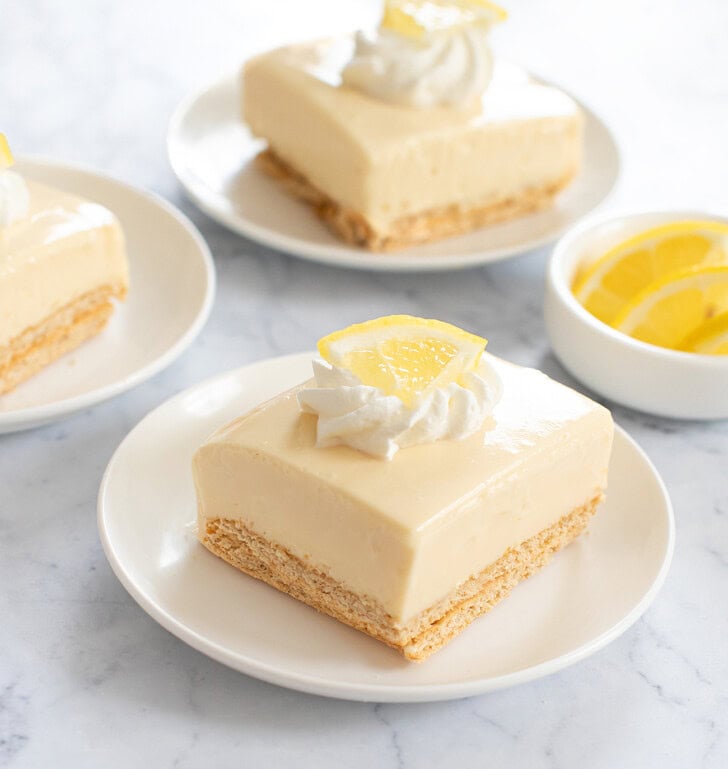 Lemon Cheesecake Bars on small white plates