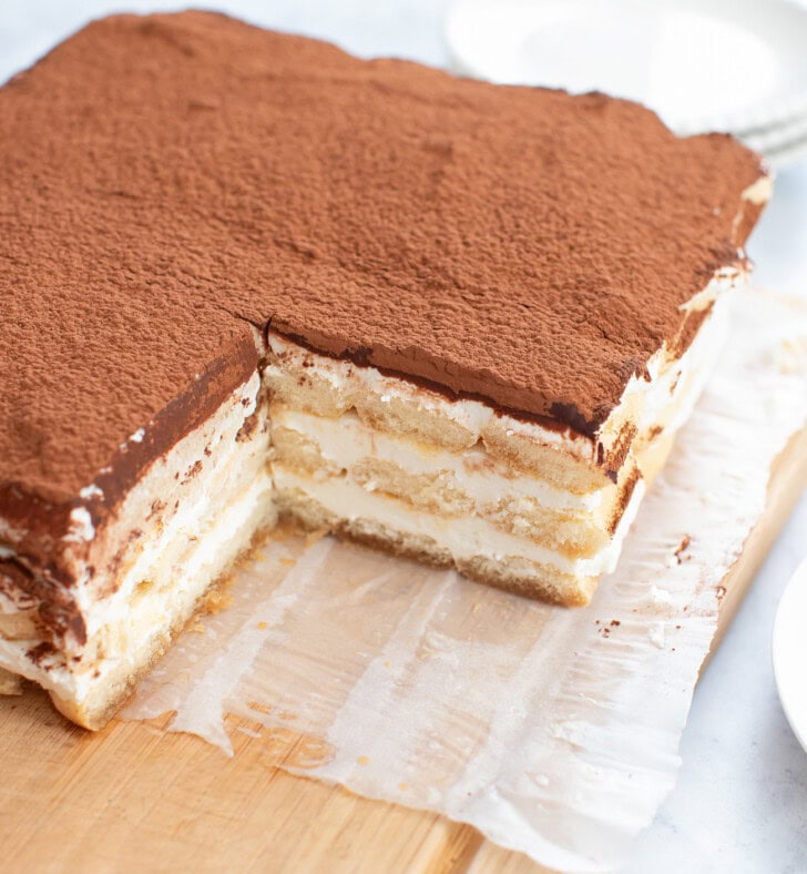 A No Bake Tiramisu Cheesecake with a square piece cut from it