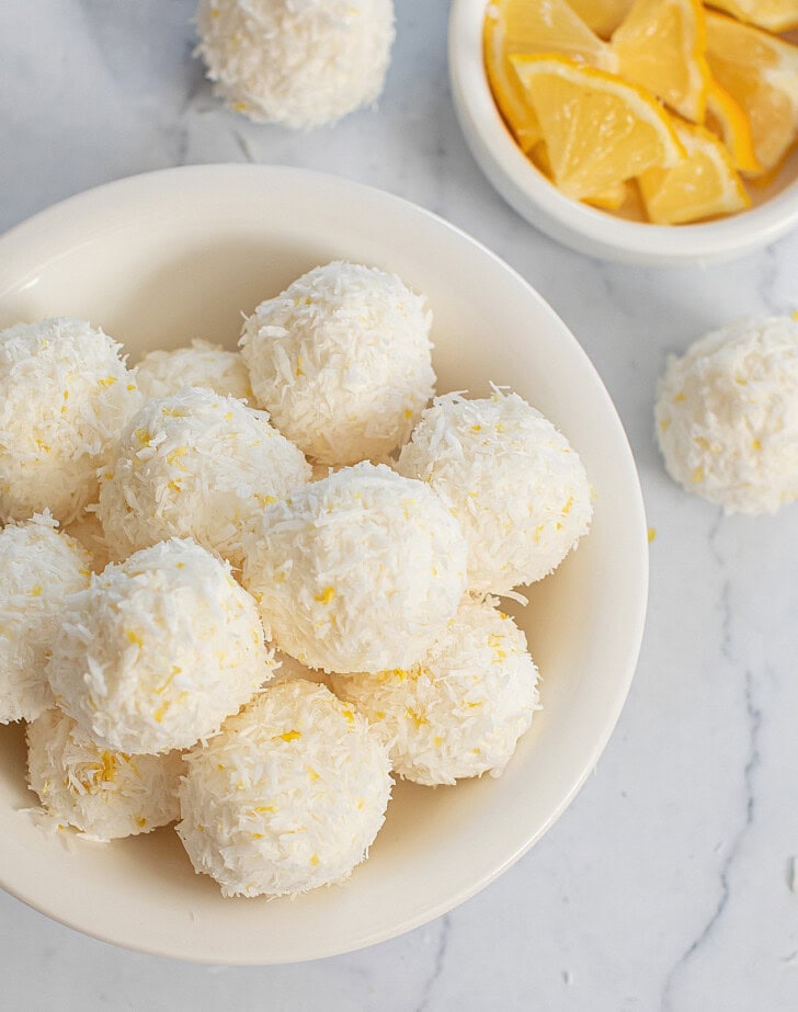 Lemon coconut balls in a white bowl
