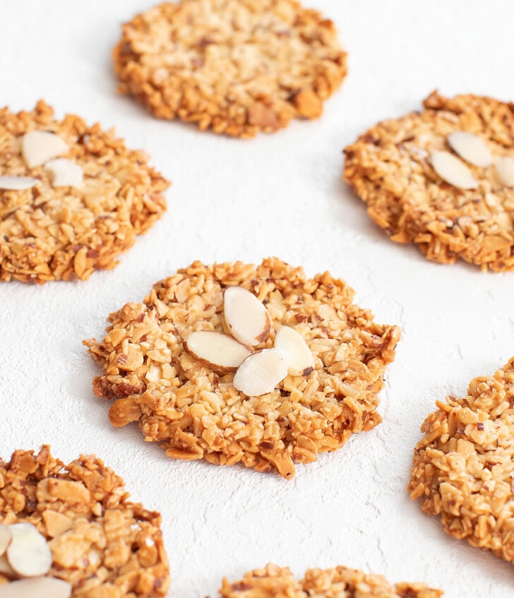 Golden brown almond cookies with slivered almonds on top