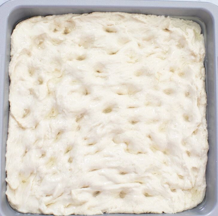 Focaccia dough in a square baking pan