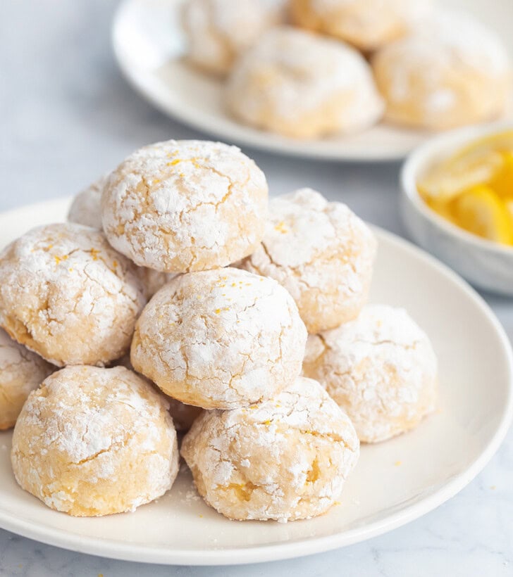 A pile of lemon cookies on a white plate