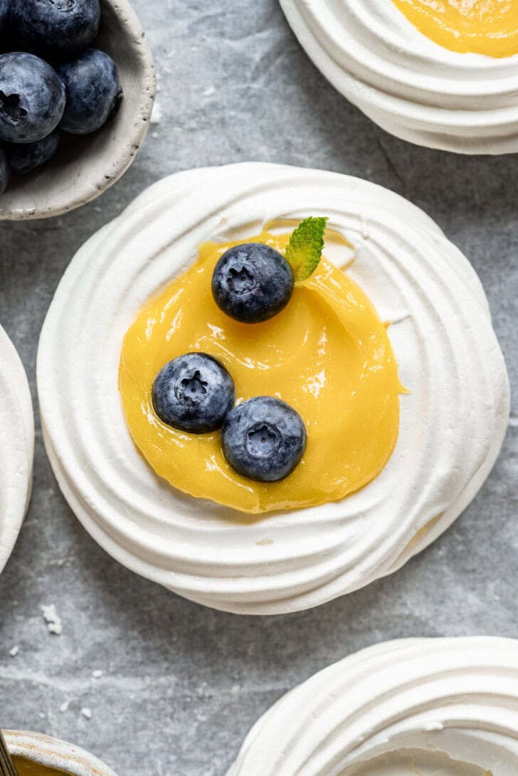 Lemon Pavlova with lemon curd in the middle and fresh blueberries