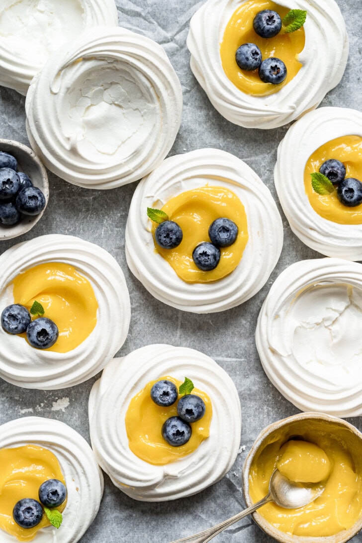 Pavlova shells filled with lemon curd and topped with fresh blueberries
