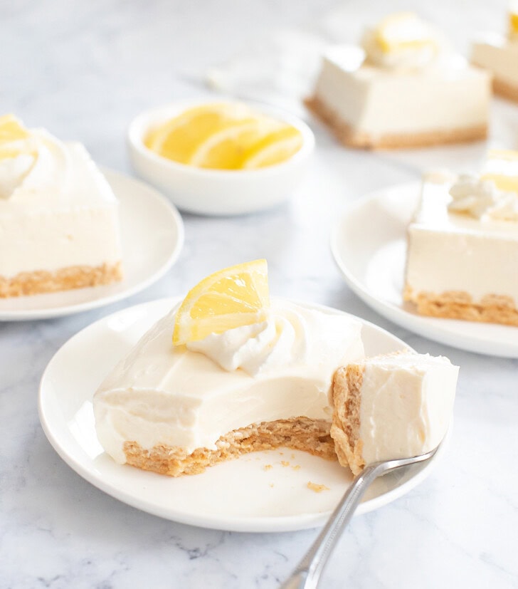 A bite of a cheesecake bar on a fork