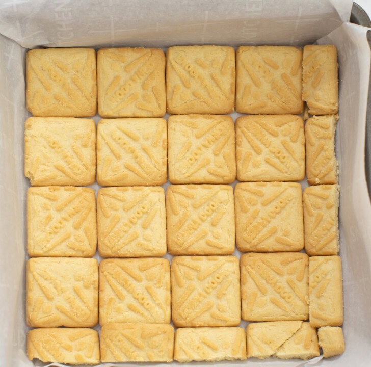A layer of shortbread cookies on the bottom of a baking pan