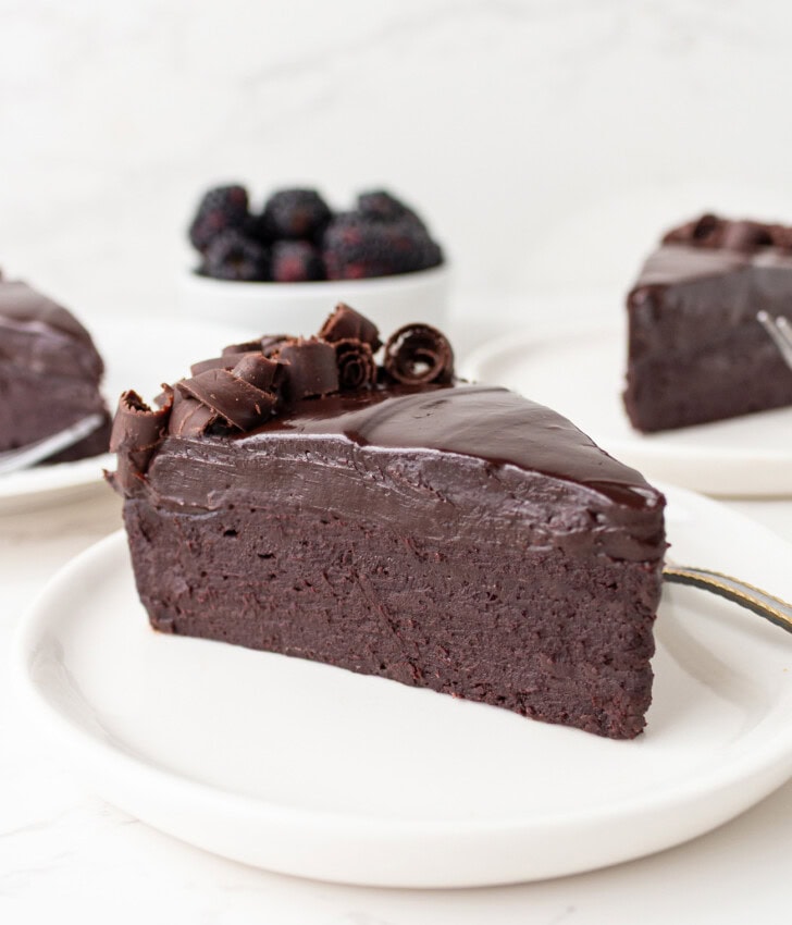 A slice of creamy chocolate cake on a plate