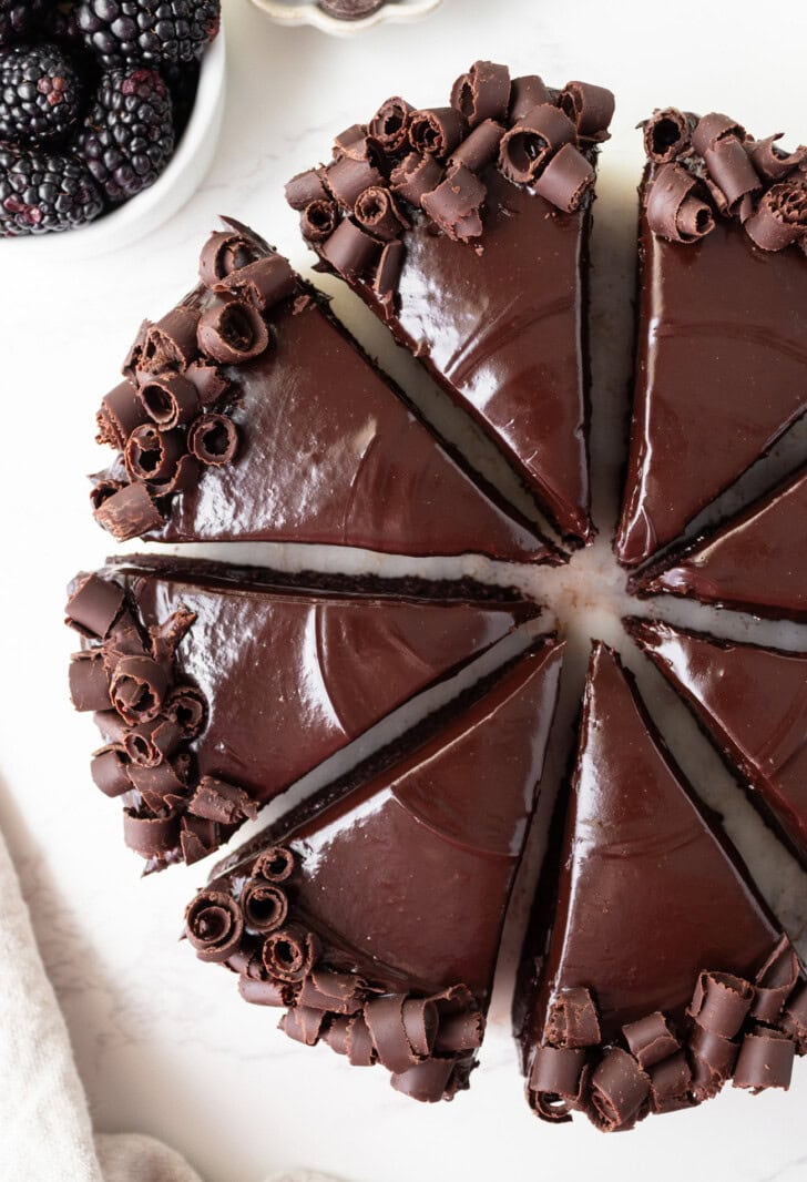 Chocolate cake slices with chocolate ganache and chocolate curls on top