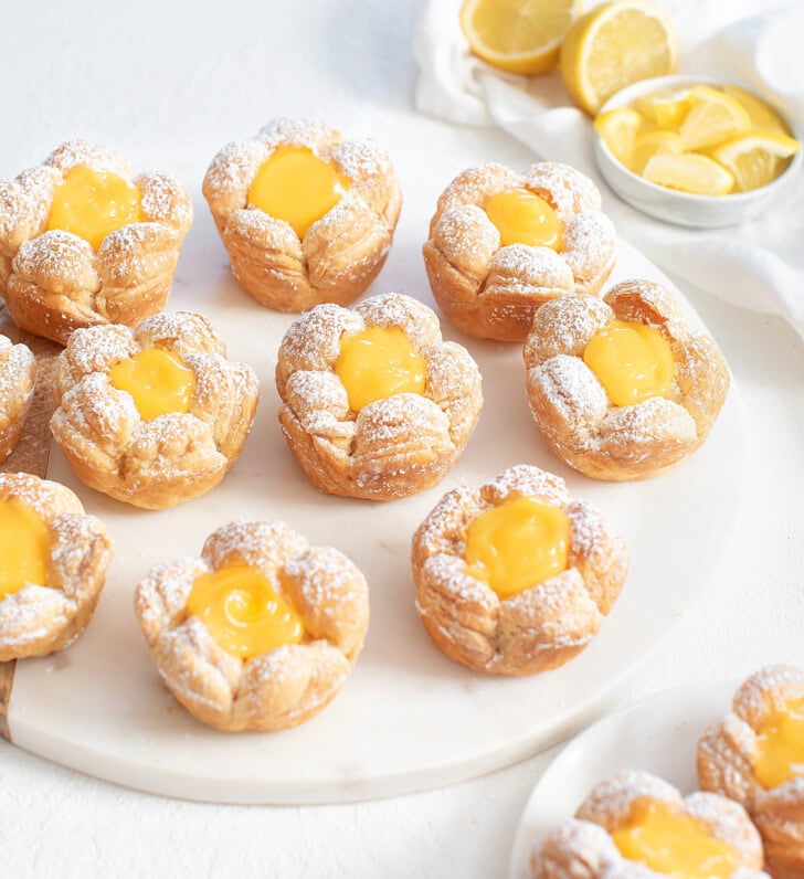 Flower shaped pastry with lemon curd in the center and dusted with powdered sugar