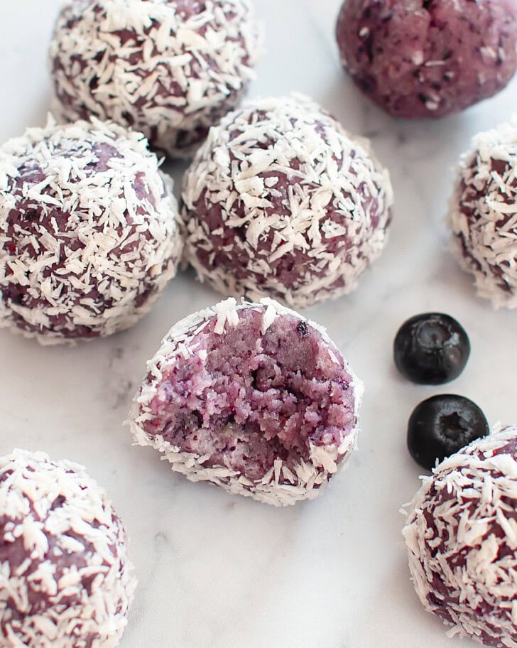A bite taken from a blueberry cake ball