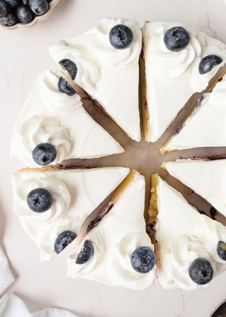 A Blueberry Cottage Cheesecake cut into slices