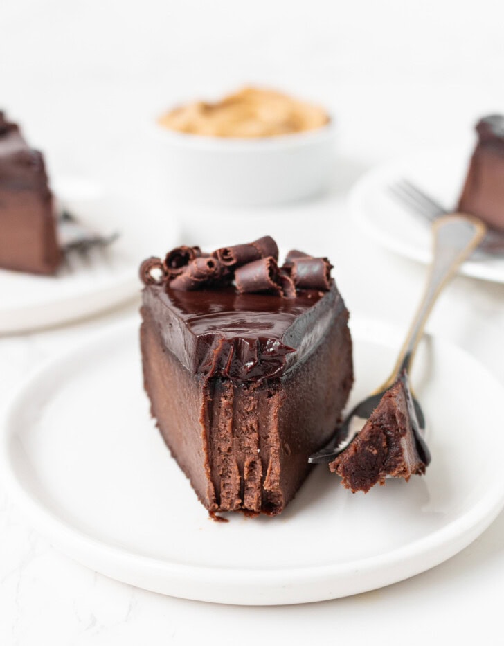 A bite on a fork taken from a slice of chocolate cake