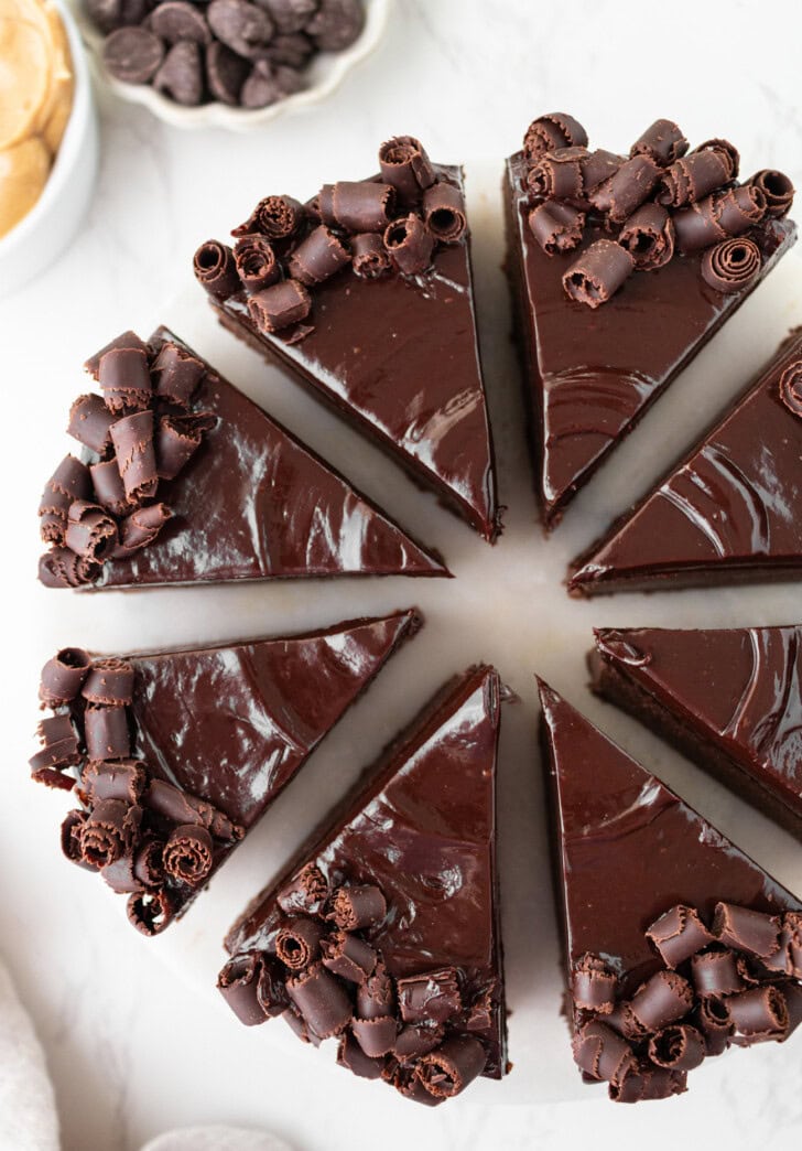 A decorated chocolate cake cut into slices