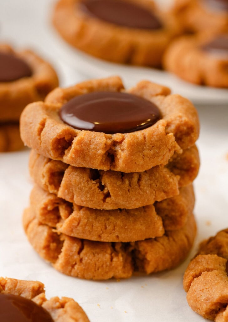 A stack of four Peanut Butter Blossom Cookies