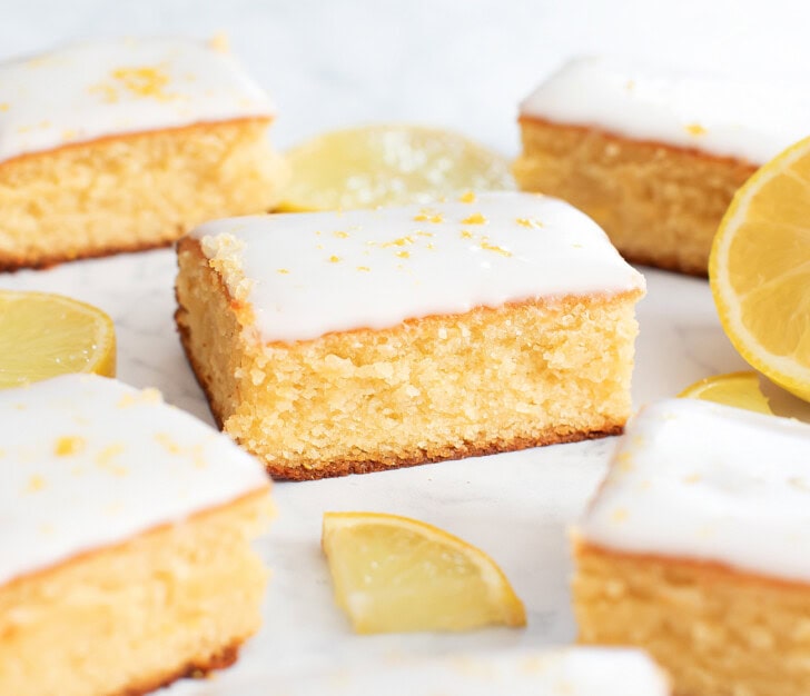 Lemon brownies with icing and lemon zest on top