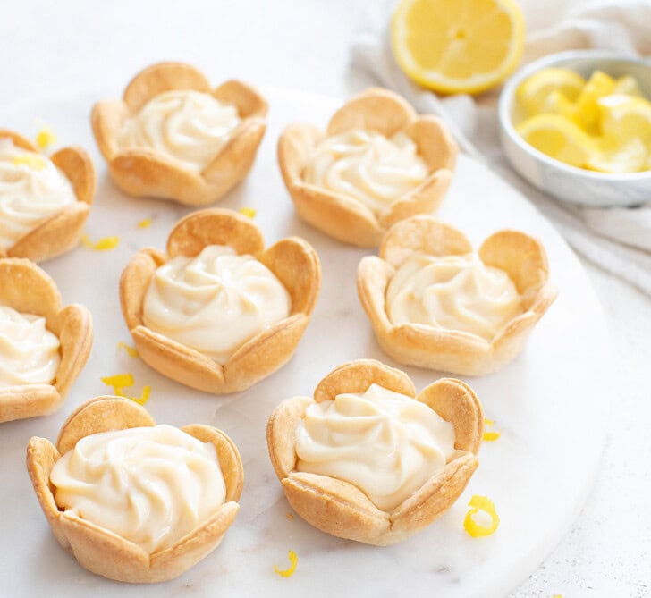 Lemon cottage cheesecake after baking and filling with fresh lemon zest