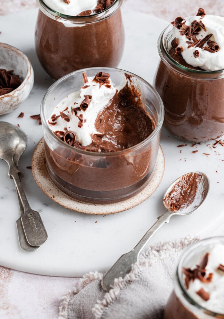 A scoop taken from a cup of chocolate mousse