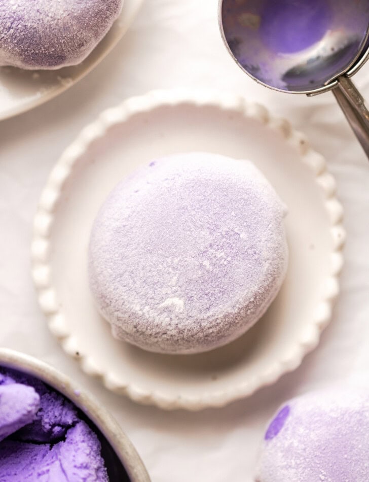 A piece of mochi ice cream on a small white plate
