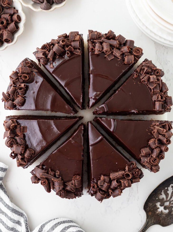 A chocolate cake decorated with chocolate ganache and chocolate curls
