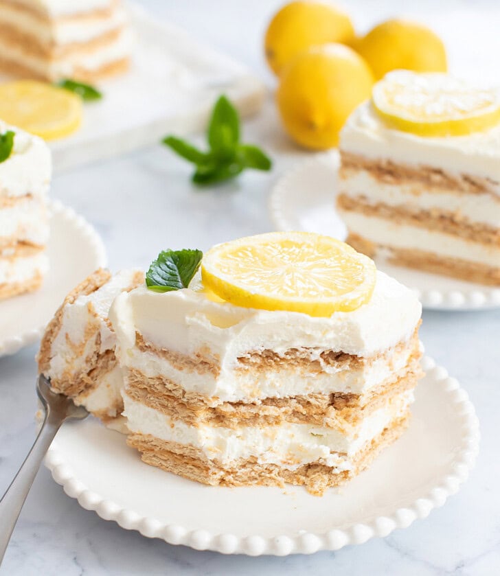 A bite taken from a slice of lemon yogurt cheesecake