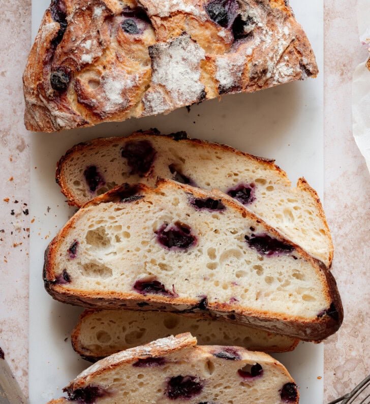 Slices cut from a loaf of blueberry bread
