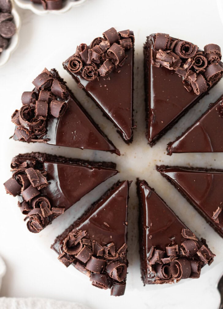 Chocolate cake slices decorated with chocolate ganache frosting and chocolate curls