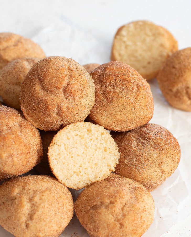 A pile of donut holes with one cut in half