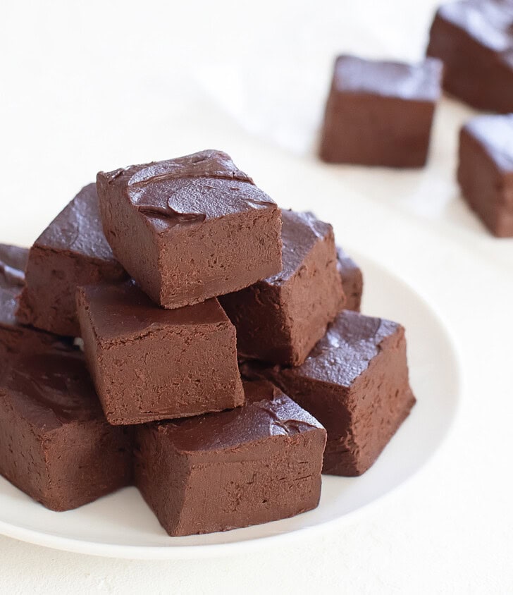 A pile of fudge pieces on a white plate
