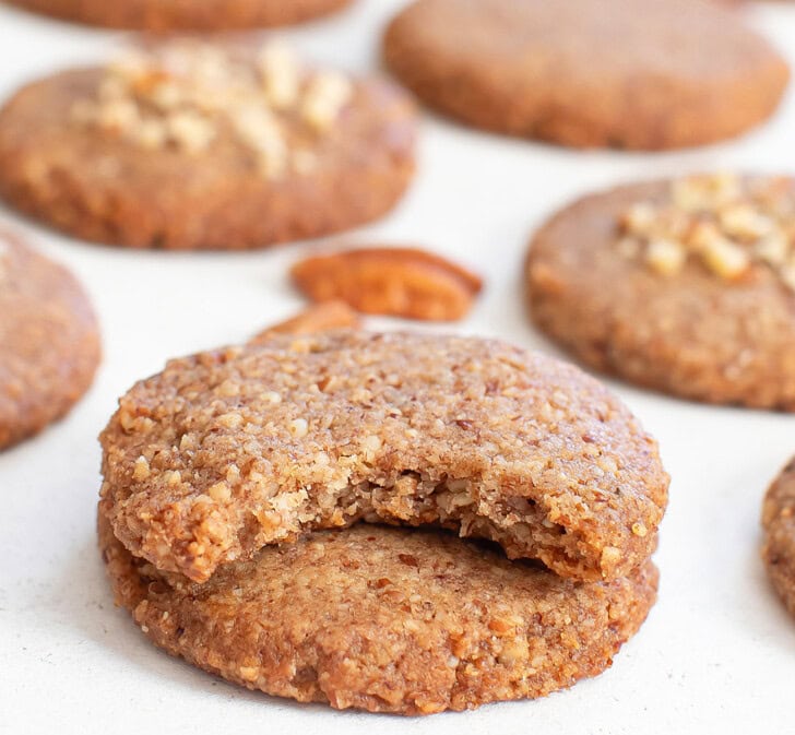 A bite taken from a pecan cookie
