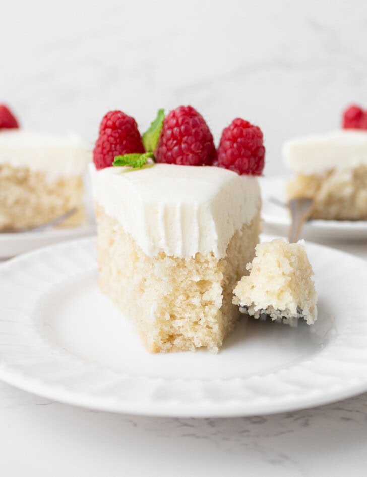 A bite taken from a slice of cake