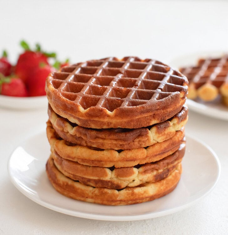 A stack of five keto waffles on a white plate