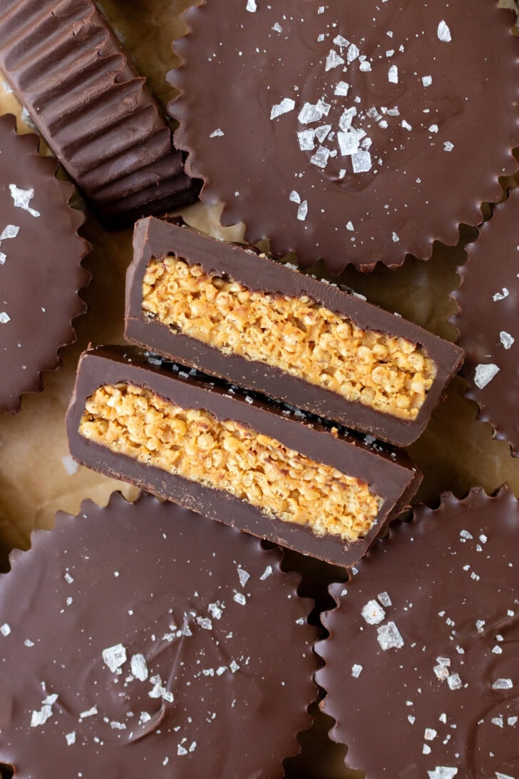 A chocolate peanut butter cup cut in half to show the filling