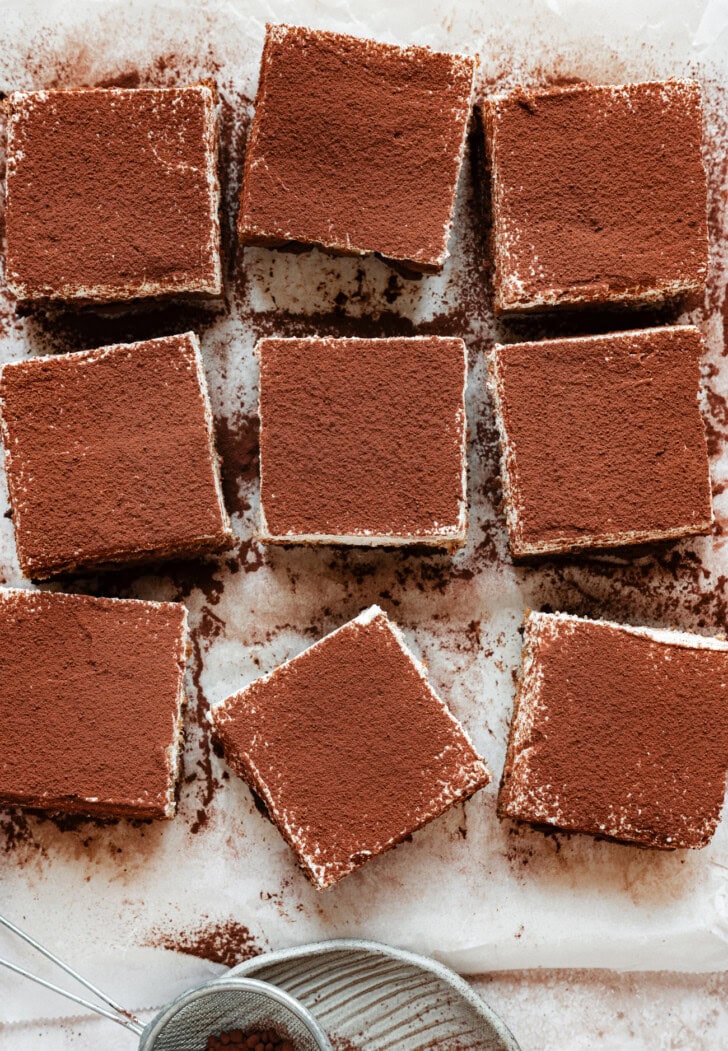 Tiramisu brownies cut into squares and dusted with cocoa powder