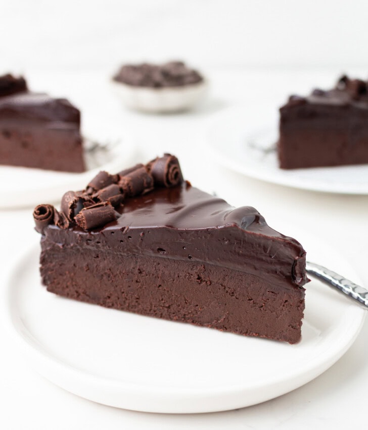 A slice of chocolate cake with chocolate ganache frosting