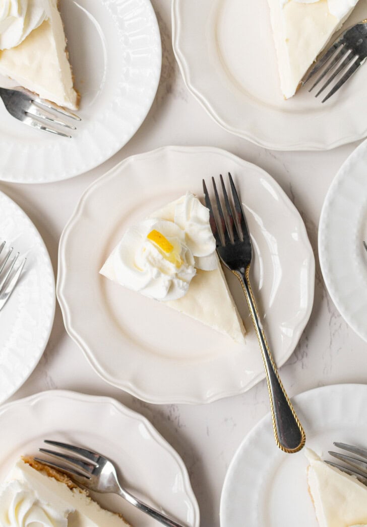 Cheesecake slices on plates with silver forks