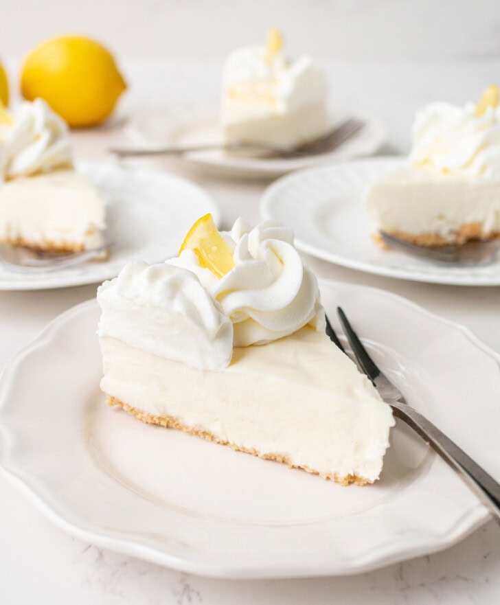 A slice of yogurt cheesecake on a plate with a fork 