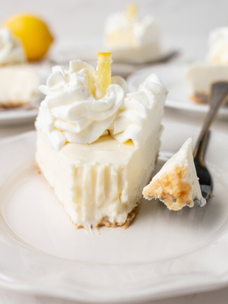 A bite taken from a slice of cheesecake