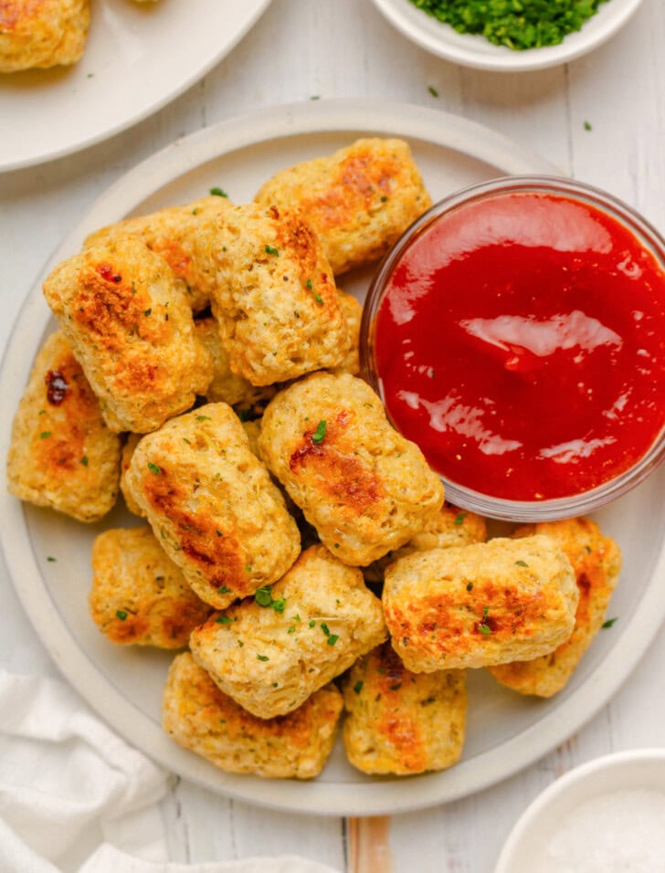 Cottage cheese tots on a plate with a dipping sauce